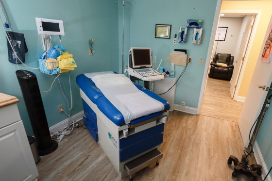 An exam table in an empty room inside a clinic