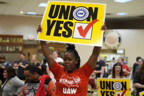 A woman holds a sign that says "Union Yes"
