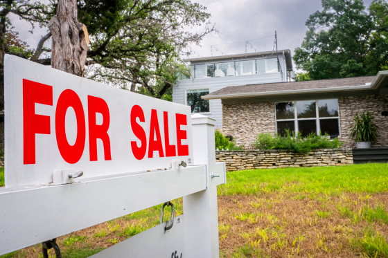 A 'for sale' sign outside a home.