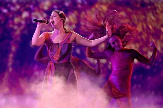 Celine Dion performing live, representing her success in the year 2021