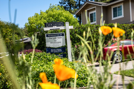 A "New Listing" sign outside a home