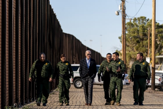 Joe Biden talks with U.S. Border Patrol agents as they walk along a stretch of the U.S.-Mexico border in El Paso Texas