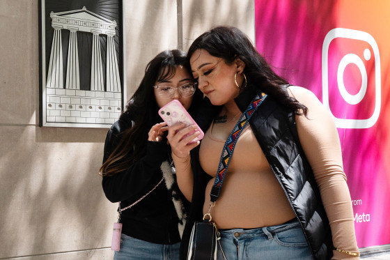 Women walk along Michigan Avenue in the Magnificent Mile shopping district