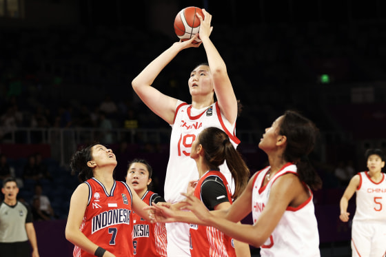 China's 7-foot-3 teen basketball star towers over her competitors in ...