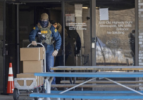 FBI agents raid the nonprofit "Feeding our Future" in St. Anthony, Minn., on Jan. 20, 2022.