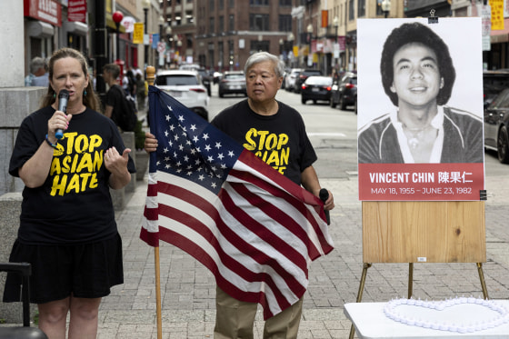 Wilson Lee holds an U.S. flag as Boston City Councilor Erin Murphy speaks.