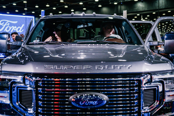 Attendees sit inside a 2022 Ford F350 Super Duty pickup truck