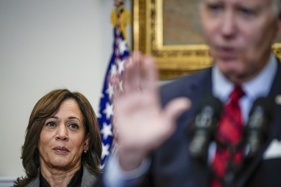 Kamala Harris looks on as Joe Biden.