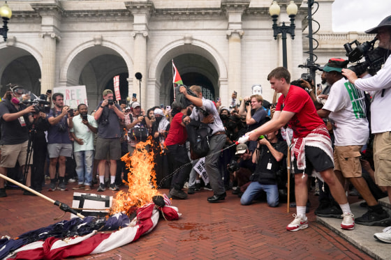 Protesters gather for Israeli PM Netanyahu's address to Congress in Washington US flag burning burners USA