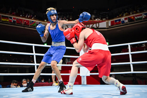 Imane Khelif, left, and Kellie Anne Harrington box each other in the ring