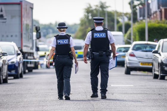 Police officers near the scene in Hart Street.