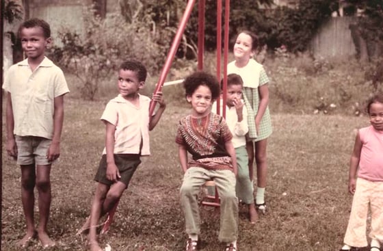 A group of children smiling outside