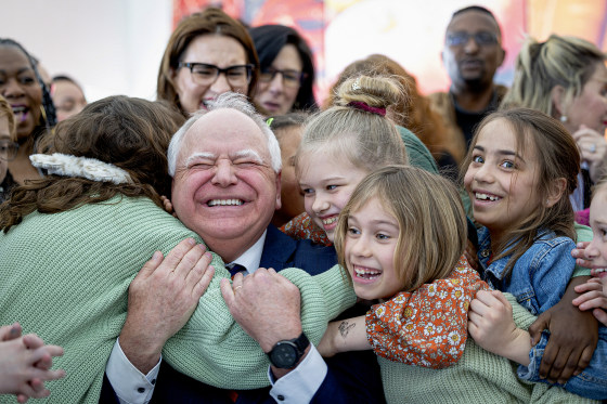 Tim Walz gets a huge hug from students.