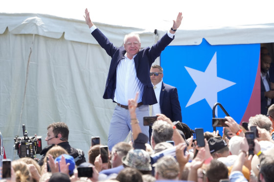 Democratic vice presidential nominee Minnesota Gov. Tim Walz arrives on stage Wednesday, Aug. 7, 2024, in Eau Claire, Wis.