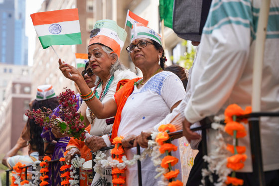 People wave Indian flags outside