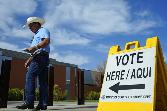 A voter walks to a precinct in El Mirage in Arizona’s primary election in July. The Supreme Court granted a Republican request to make the state enforce part of a law requiring people to show proof of citizenship to vote.