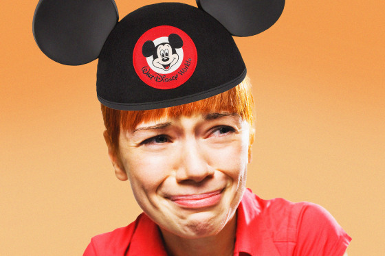 A woman wearing a Walt Disney World Mickey ears hat cries.