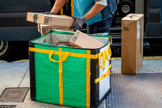 A worker delivers Amazon packages.