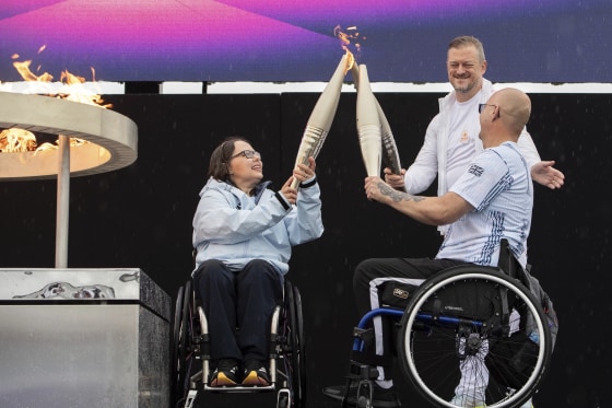 British Paralympians Helene Raynsford and Gregor Ewan light the Paralympic Flame in Stoke Mandeville, England.