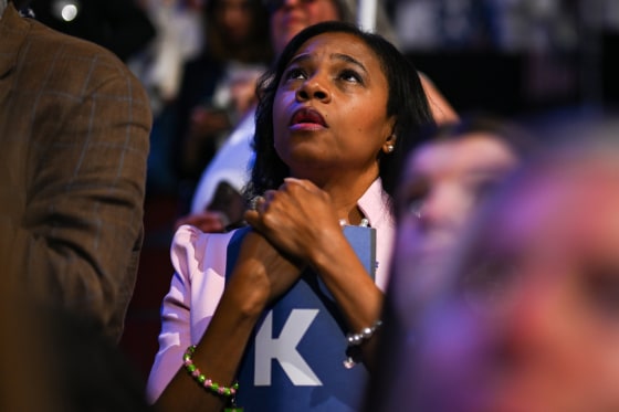 An attendee looks up as she listens 