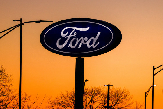 Ford's logo against an orange sky