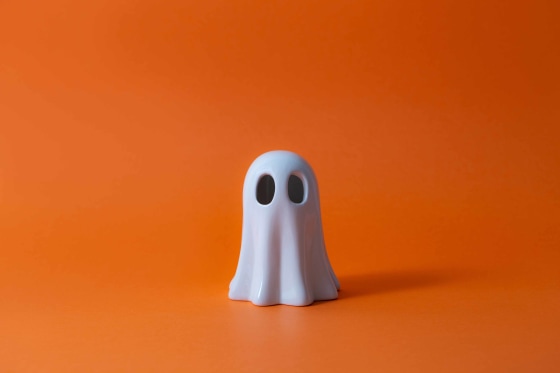 Halloween Ghost on orange background.