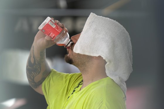 A construction worker hydrates at the Shedd Aquarium in Chicago on Aug. 27, 2024.