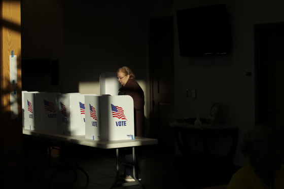 A voter casts her ballot at a polling place, in Ridgeland, Miss.