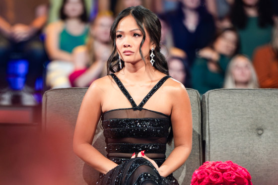 Jenn Tran sits on a couch in front of a studio audience