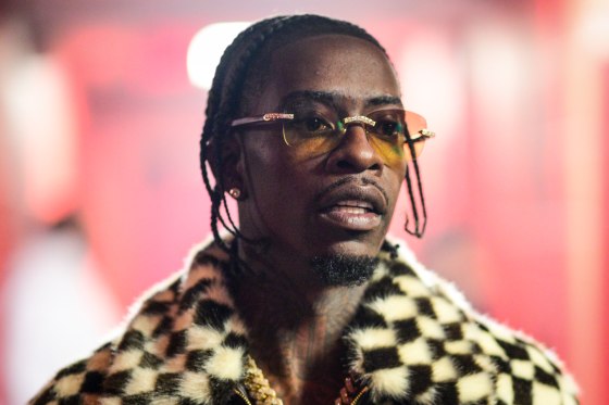 Rich Homie Quan wearing sunglasses and a checkered coat