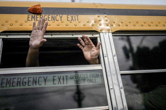 Nicaraguan citizens wave from a bus.