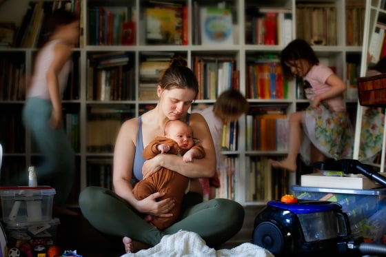 Capturing Emotions: Tired Mother's Desperation with Baby in Arms, Unfocused Kids, and Household Chaos in the Living Room