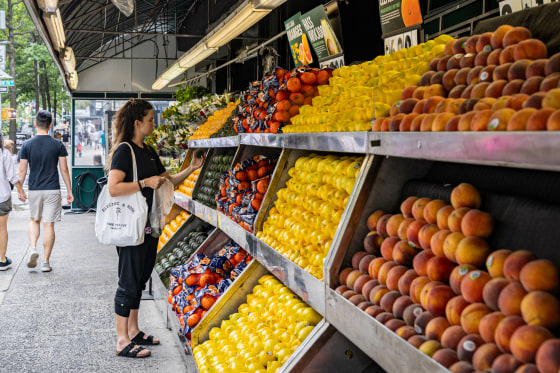 A person buys produce.