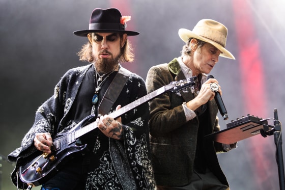 Dace Navarro, left, plays guitar while Perry Farrell sings on stage