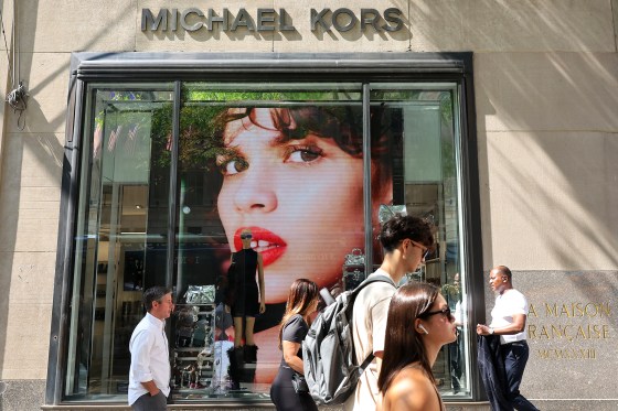 Image: pedestrians store michael kors nyc new york