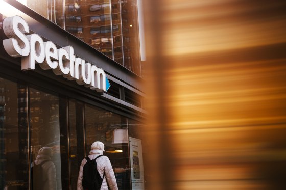 A person walks past a Spectrum store