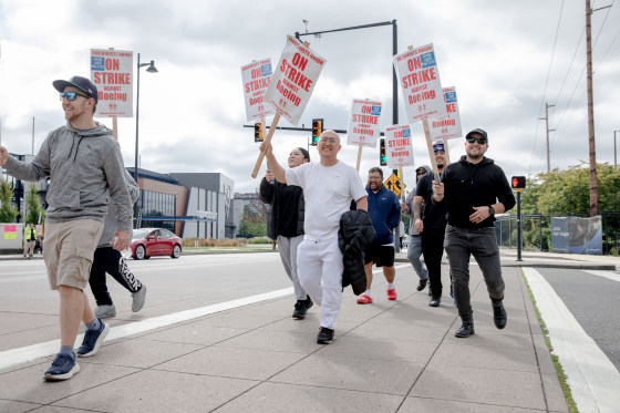 Striking Boeing workers picket outside the Boeing Co. manufacturing facility