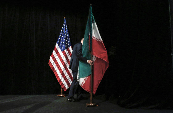 A staff removes the Iranian flag from the stage