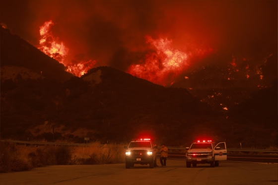 Firefighting personnel monitor the blaze as Highway 330 is engulfed by the Line Fire near Running Springs, California, on Saturday.