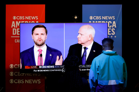 JD Vance And Tim Walz on TV screens.