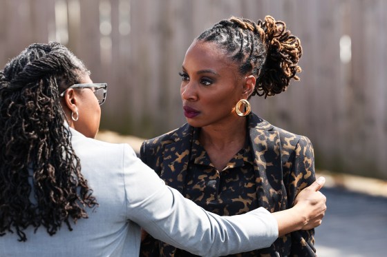 Anisa Nyell Johnson, left, holds on to Shanola Hampton outside