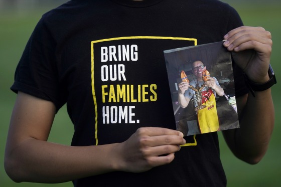 Harrison Li holds a photo of his father, Kai Li, in Palo Alto, Calif., on Jan. 23.