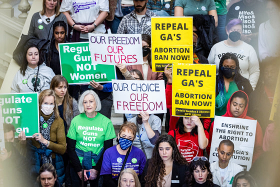 People protest and hold signs advocating for abortion rights