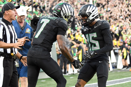 Oregon Ducks wide receiver Tez Johnson (15) celebrates a touchdown by Oregon Ducks wide receiver Evan Stewart (7) in the second quarter during a game against the Ohio State Buckeyes on Saturday. 