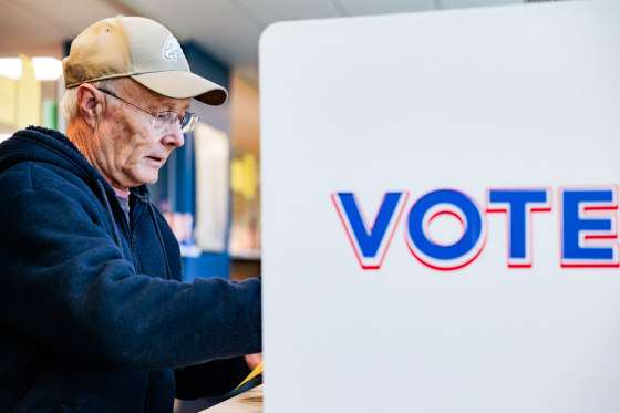 A man votes in a voting booth
