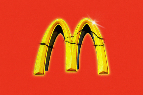 Distressed and glowing McDonald's logo against red background 