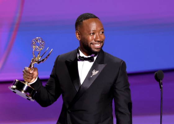 Lamorne Morris  smiles while holding his Emmy