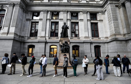 Image: Philadelphia residents wait in a line around city hall to cast their ballot 