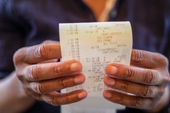 Woman holding retail receipt