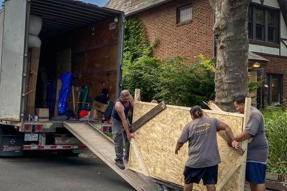 People loading up truck with furniture.